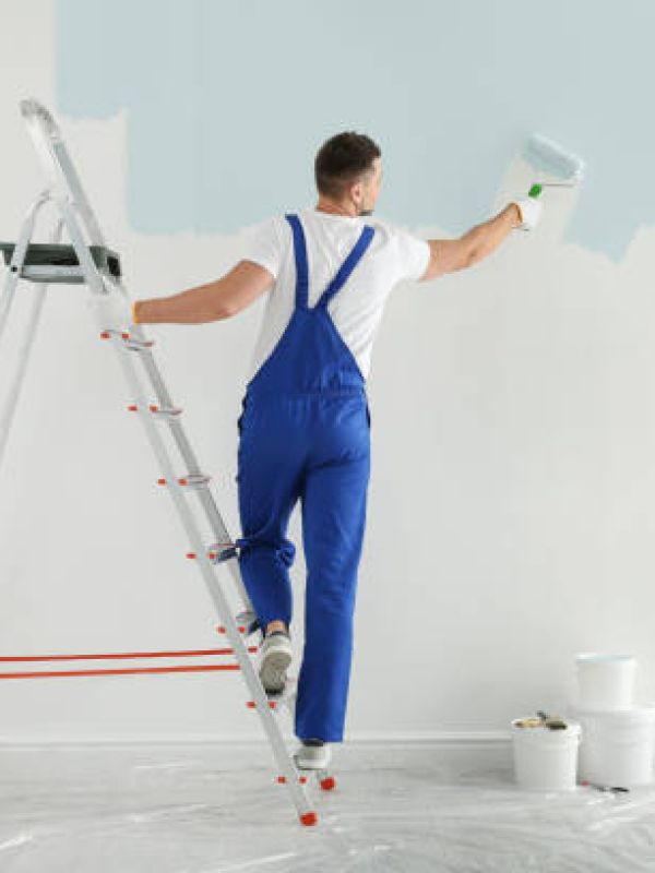 man-painting-wall-with-light-blu man-painting-wall-with-light-blu