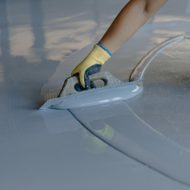 worker-applies-gray-epoxy-resin